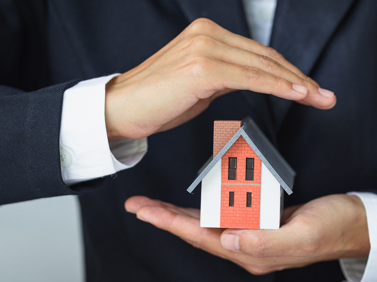man with house in hand