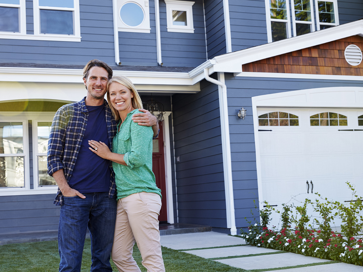 couple in front of house
