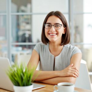 a woman with her laptop and coffee