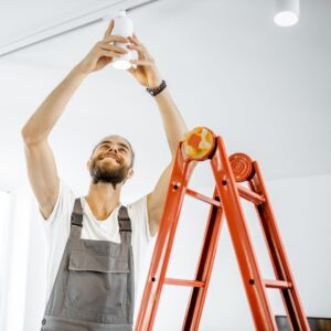 person installing new light fixture