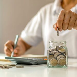 person putting money in jar