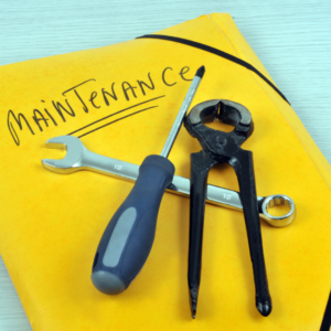 Yellow folder with word "mainenance" on it and a screwdriver, and other tools.