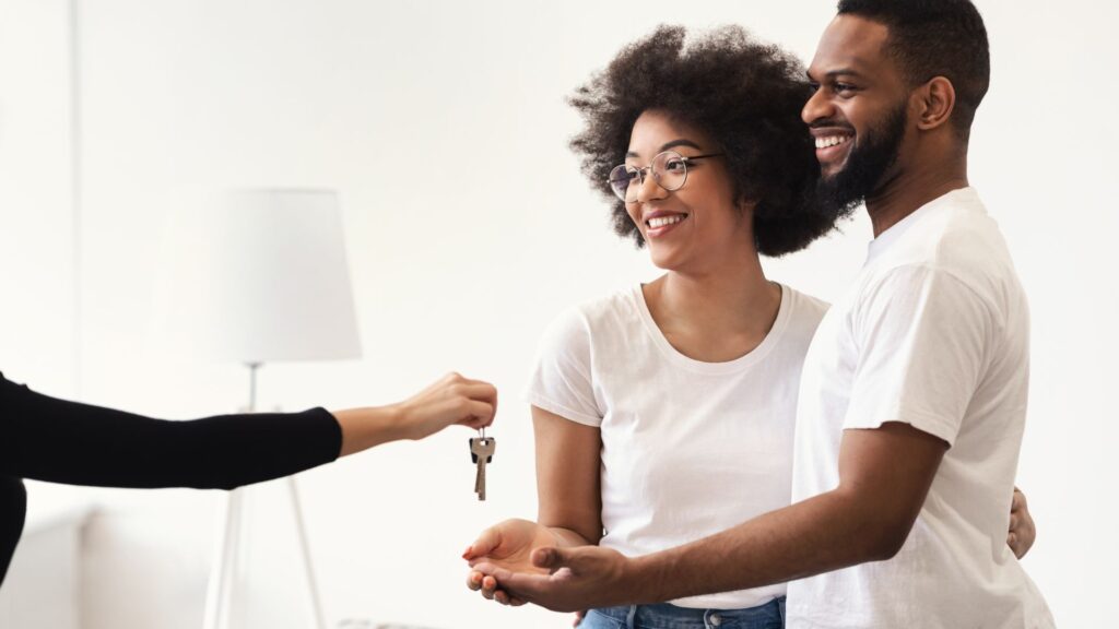 couple getting keys to a house