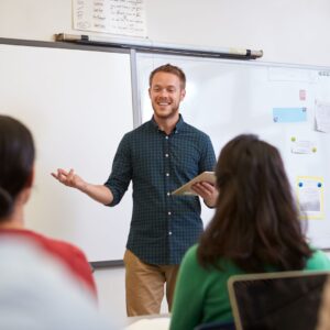 A teacher at the front of a classroom