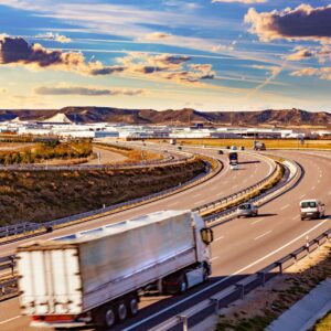 Action shot of a semi truck driving on a curving interstate