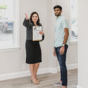 A real estate agent showing a house to a client