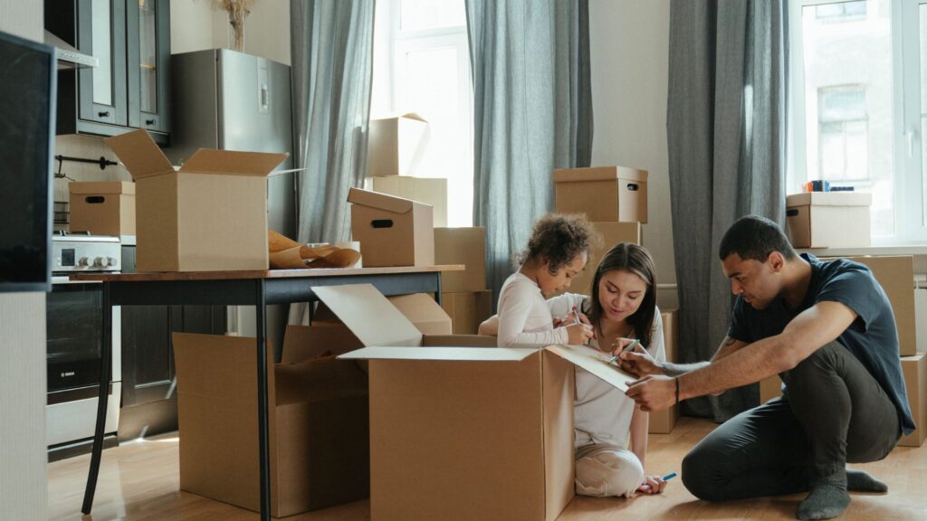 A family surrounded by moving boxes