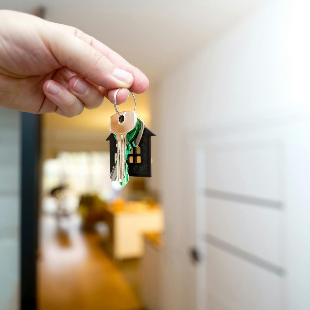 person opening front door of house